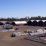 An industrial work site using container dome shelters.